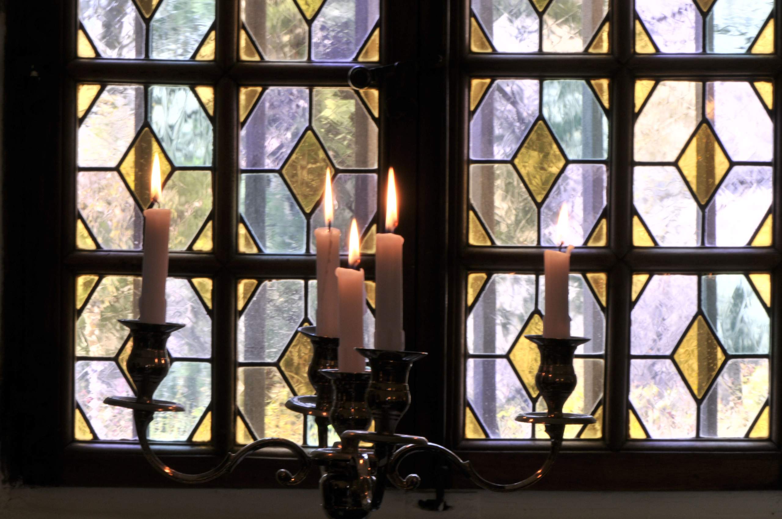 Stained-glass windows close-up and candelabrum